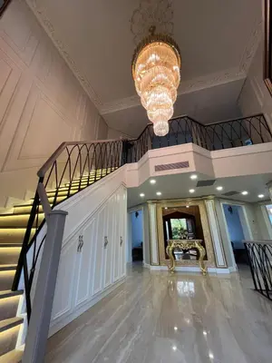 a large lobby with a staircase and a chandelier at Nil Konaklama Sapanca in Sapanca