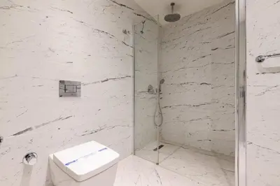 a white bathroom with a shower and a toilet at Beautiful Deluxe 1BD Condo PoolGymParking! #373 in Istanbul