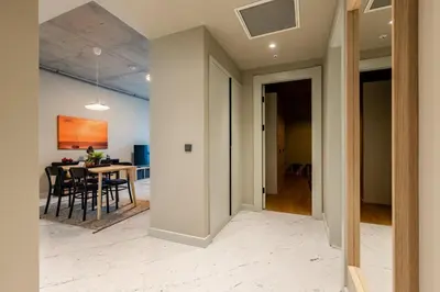 a hallway leading to a dining room and a living room at Beautiful Deluxe 1BD Condo PoolGymParking! #373 in Istanbul
