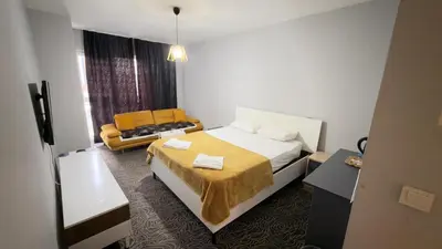 a hotel room with a bed and a couch at Güven Suit in Esenyurt