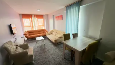 a living room with a couch and chairs and a table at Güven Suit in Esenyurt