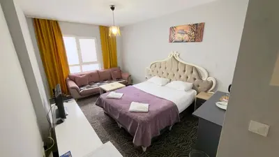a hotel room with a bed and a couch at Güven Suit in Esenyurt