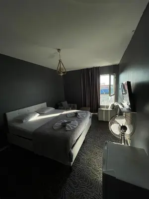 a bedroom with a large bed and a window at Güven Suit in Esenyurt