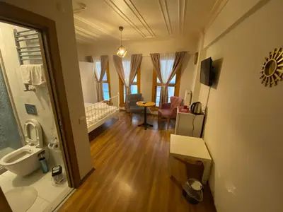 a room with a bathroom with a sink and a toilet at Konak Akaretler Suit in Istanbul