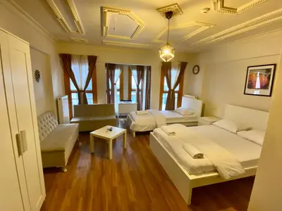 a living room with two beds and a couch at Konak Akaretler Suit in Istanbul