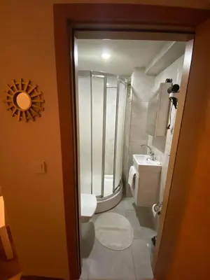 a bathroom with a toilet and a sink at Konak Akaretler Suit in Istanbul