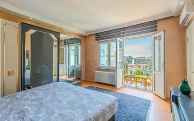 a bedroom with a bed and large windows at Palas Apartments in Istanbul