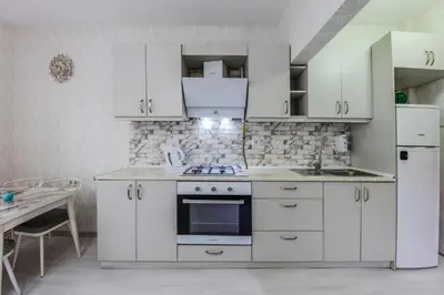 a kitchen with white cabinets and a stove top oven at Palas Apartments in Istanbul