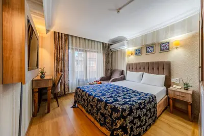 a hotel room with a bed and a desk at Hamit Hotel Istanbul - Special Category in Istanbul