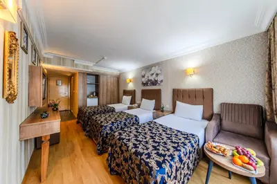 a hotel room with three beds and a couch at Hamit Hotel Istanbul - Special Category in Istanbul