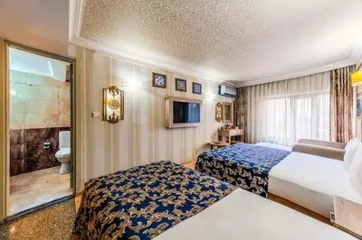 a hotel room with two beds and a bathroom at Hamit Hotel Istanbul - Special Category in Istanbul
