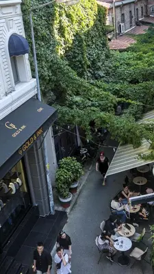 a group of people sitting at tables outside a restaurant at Zulu Suites in Istanbul