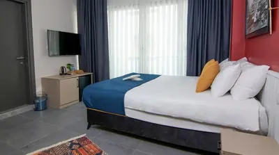 a hotel room with a bed and a television at Zulu Suites in Istanbul