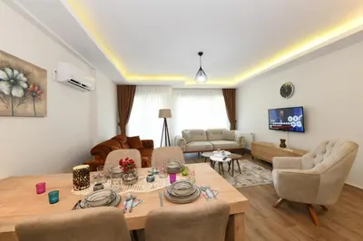 a living room with a table and chairs and a couch at Perihan Apartments in Istanbul