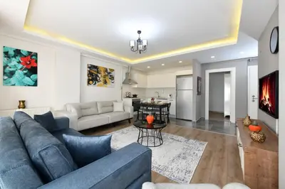 a living room with a blue couch and a table at Perihan Apartments in Istanbul