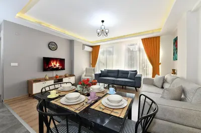 a living room with a table and a couch at Perihan Apartments in Istanbul