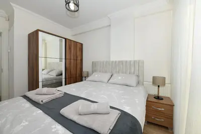 a bedroom with a large bed and a mirror at Perihan Apartments in Istanbul