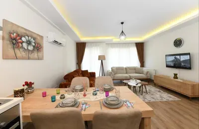 a living room with a table with chairs and a couch at Perihan Apartments in Istanbul