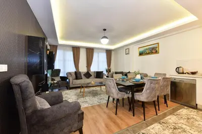 a living room with a table and chairs at Kardes Apartment in Istanbul