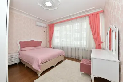 a pink bedroom with a pink bed and a window at Nasiroglu Apartment in Istanbul