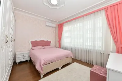 a pink bedroom with a pink bed and windows at Nasiroglu Apartment in Istanbul