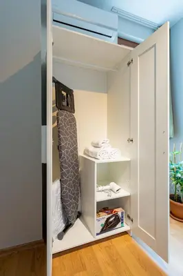 a room with a closet with a bed and shelves at Lovely and Snug Flat, Just Steps from Istiklal Street in Istanbul