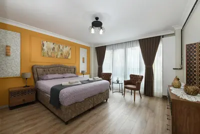 a bedroom with a bed and a table and chairs at Space Apartments in Istanbul