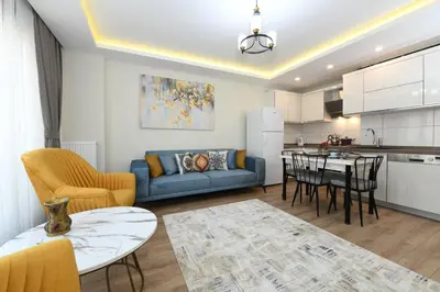 a kitchen and living room with a blue couch and a table at Space Apartments in Istanbul