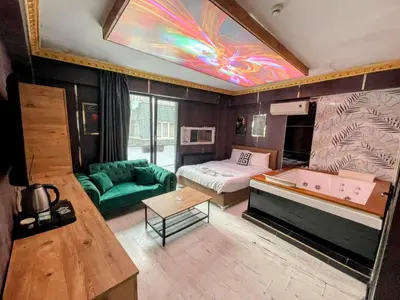 a living room with a bed and a room with a couch at Neo Suit I Hotel in Istanbul