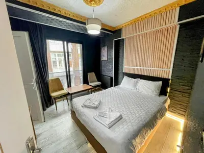 a bedroom with a bed and a table and chairs at Neo Suit I Hotel in Istanbul