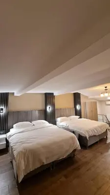 two beds in a large room with two at Golden Arrow delüx Dublex in Istanbul
