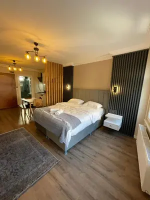 a bedroom with a large bed and a table at Golden Arrow delüx Dublex in Istanbul