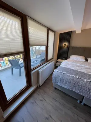 a bedroom with a bed and a large window at Golden Arrow delüx Dublex in Istanbul