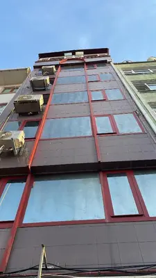 a tall building with a lot of windows on it at Family House in Istanbul