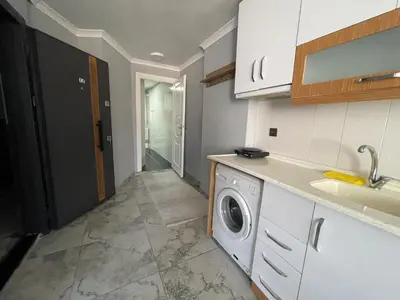 a kitchen with a washing machine and a sink at Family House in Istanbul