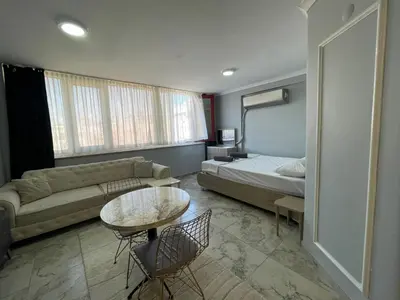 a room with a bed and a couch and a table at Family House in Istanbul