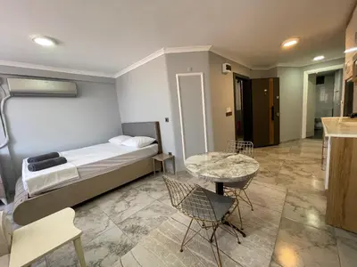 a bedroom with a bed and a table and chairs at Family House in Istanbul