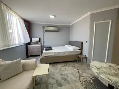 a small room with a bed and a couch at Family House in Istanbul