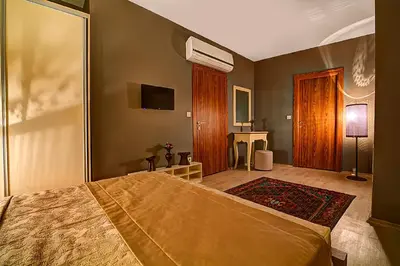 a bedroom with a large bed and a tv at Million Old City Apartment in Istanbul