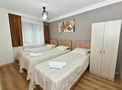 a bedroom with two beds with white sheets at Bomonti Apartments in Istanbul