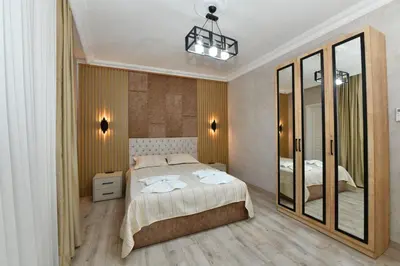 a bedroom with a bed and a large mirror at VIP Apartment in Istanbul