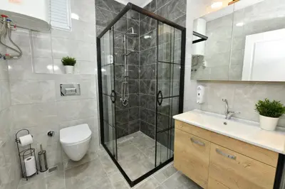 a bathroom with a shower and a toilet and a sink at VIP Apartment in Istanbul
