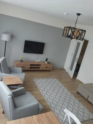 a living room with a tv and a couch and a table at Fully Renovated apartment in Istanbul