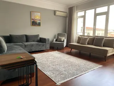 a living room with a couch and a chair at Fully Renovated apartment in Istanbul