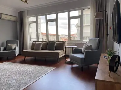 a living room with a couch and two chairs at Fully Renovated apartment in Istanbul