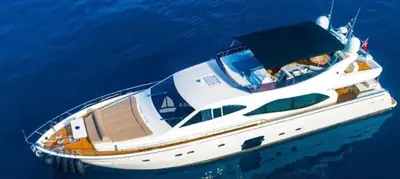 a white boat floating in the blue water at Hans Beys yatch in Istanbul