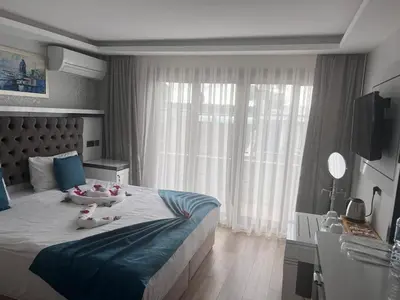 a bedroom with a large bed with two stuffed animals on it at Maritime Boutique Hotel in Istanbul