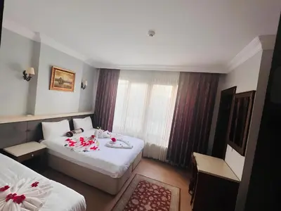 a hotel room with two beds and a window at Maritime Boutique Hotel in Istanbul