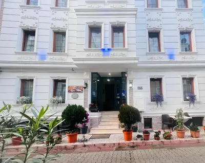 a white building with potted plants in front of it at Maritime Boutique Hotel in Istanbul