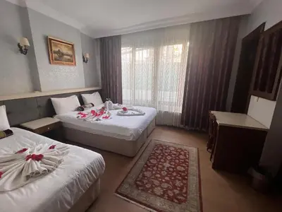 a hotel room with two beds and a window at Maritime Boutique Hotel in Istanbul